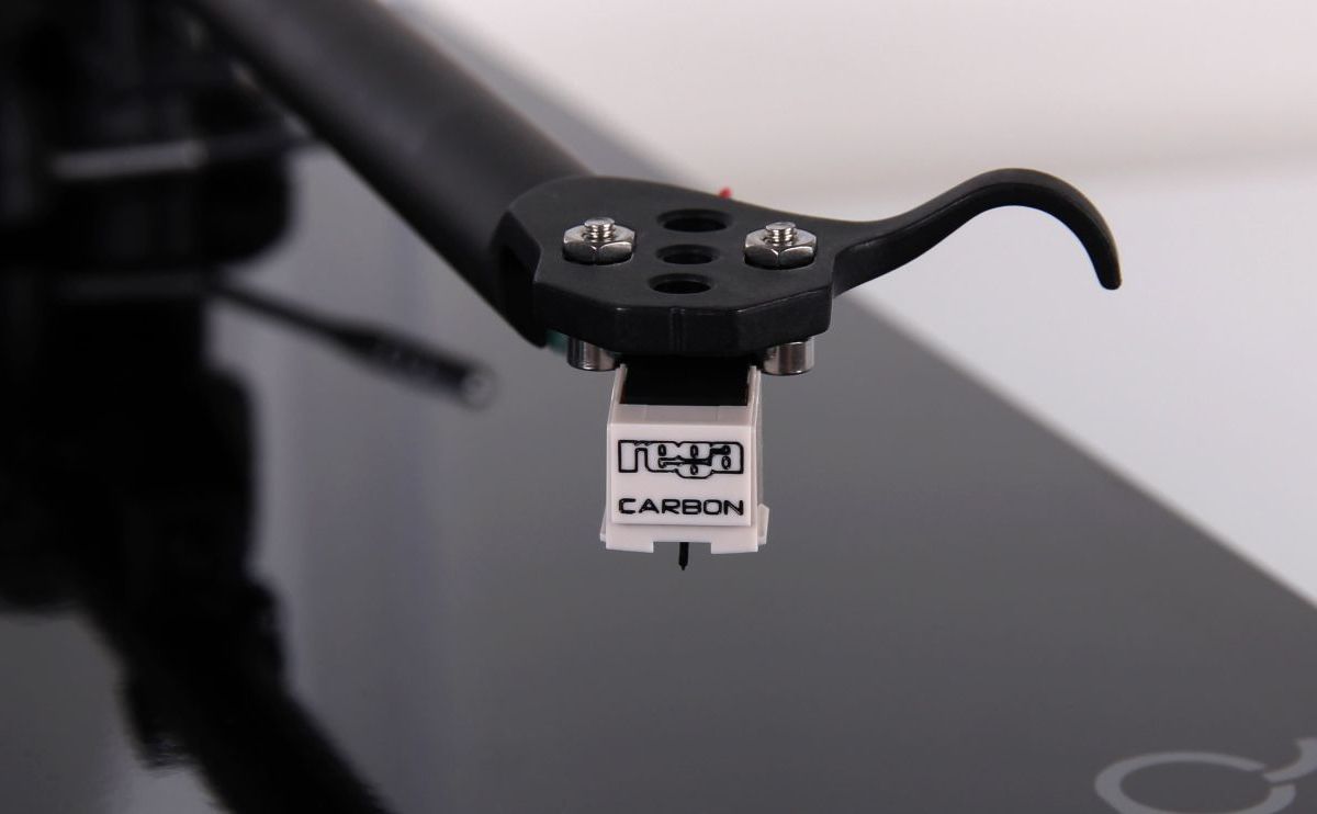 The Carbon fitted to a black Rega headshell and finger lift, mounted on a dark plinth turntable