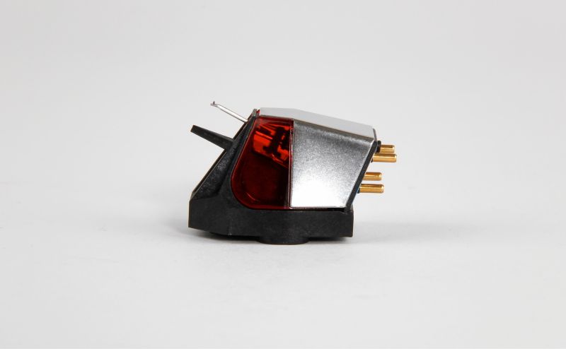 The Nd3 in studio three-quarter view, red window panel beside a mirror-polished silver flank on the black moulded body, gold pins at the rear