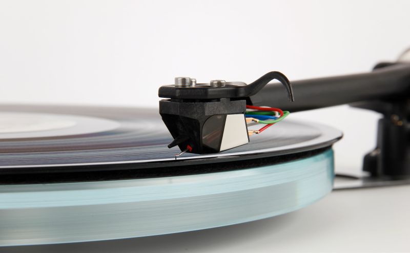 The Nd5 fitted to a Rega tonearm and tracking a record on a glass platter, tag wires and finger lift in view