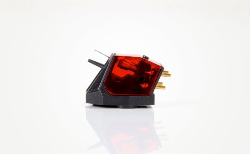 The Ania Pro in side view, the red cover and the fine cantilever projecting below, reflected in the white surface