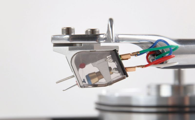 The Apheta 3 in profile on the arm above the platter, smoked cover and stylus over the record surface