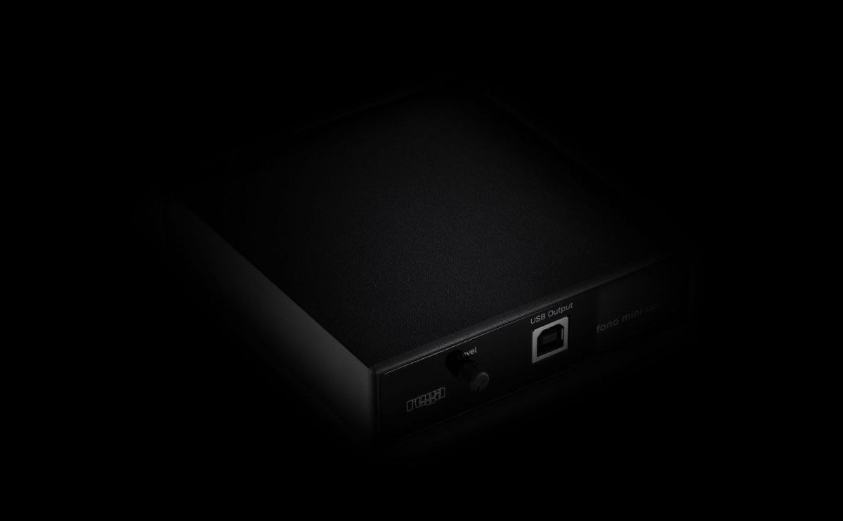 The Fono Mini A2D MK2 lit from one side against a black background, the USB socket and the front controls just catching the light