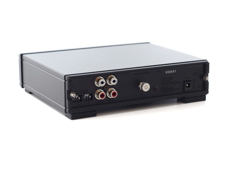 The rear of the Fono MC MK4 at an angle, with the DIP switch bank for gain and loading beside the input and output phono sockets