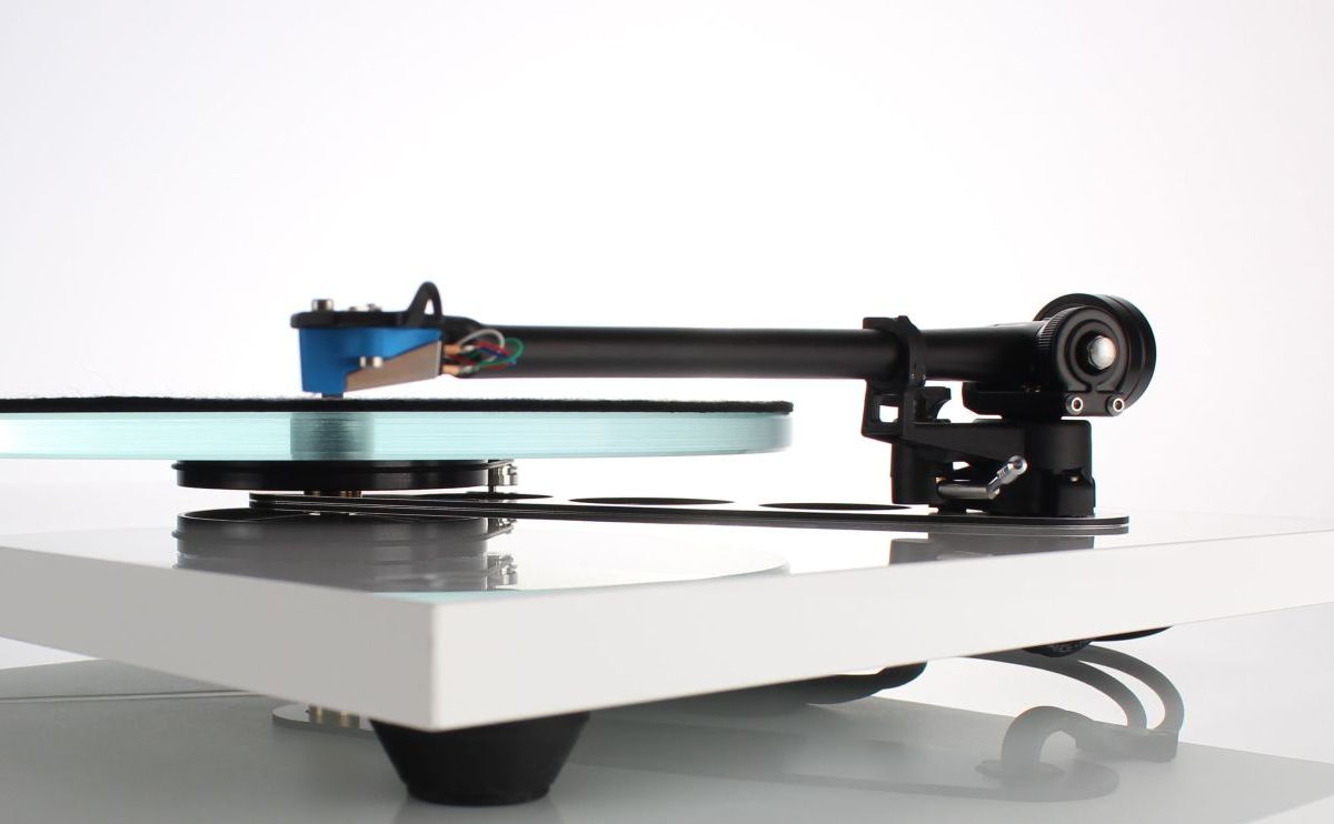 The RB330 mounted on a white turntable, cartridge lowered over the glass platter