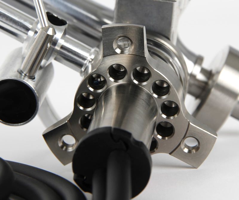 Macro of the one-piece titanium vertical bearing housing, drilled to shed mass