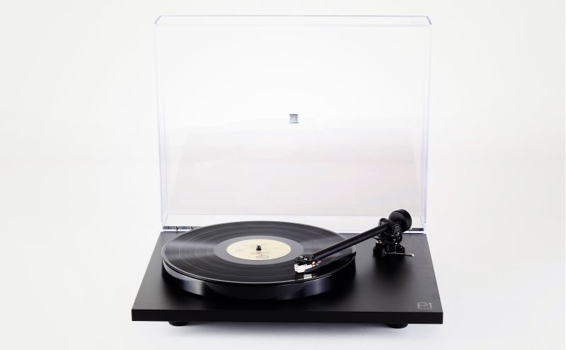 The Planar 1 turntable alone, dust cover raised, a record on the platter and the RB110 tonearm resting on its support