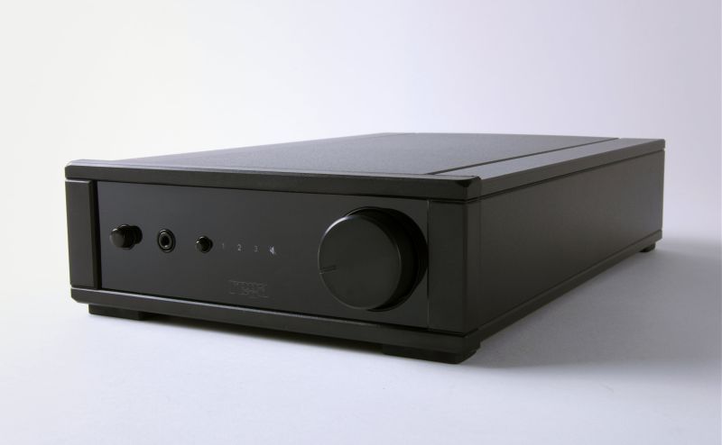The io amplifier from a front three-quarter angle, showing the power switch, headphone socket, input selector and the large volume knob