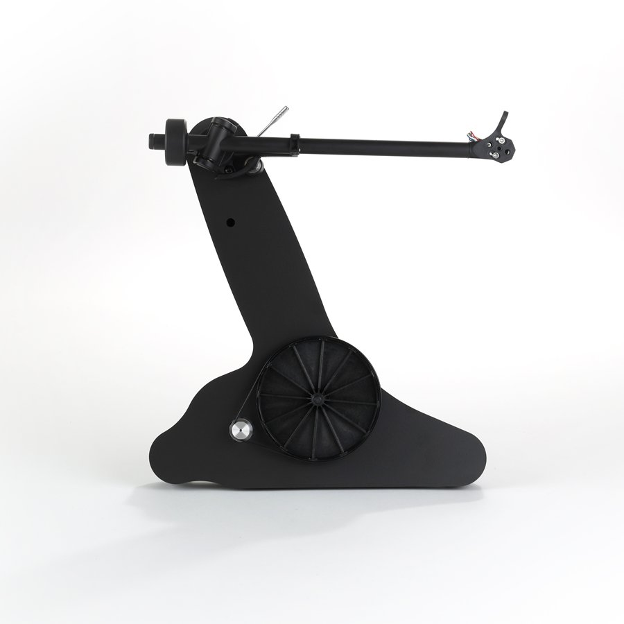 The bare matt black plinth of the Rega Replay seen from above: the sub-platter, the motor pulley and the RB110 tonearm.