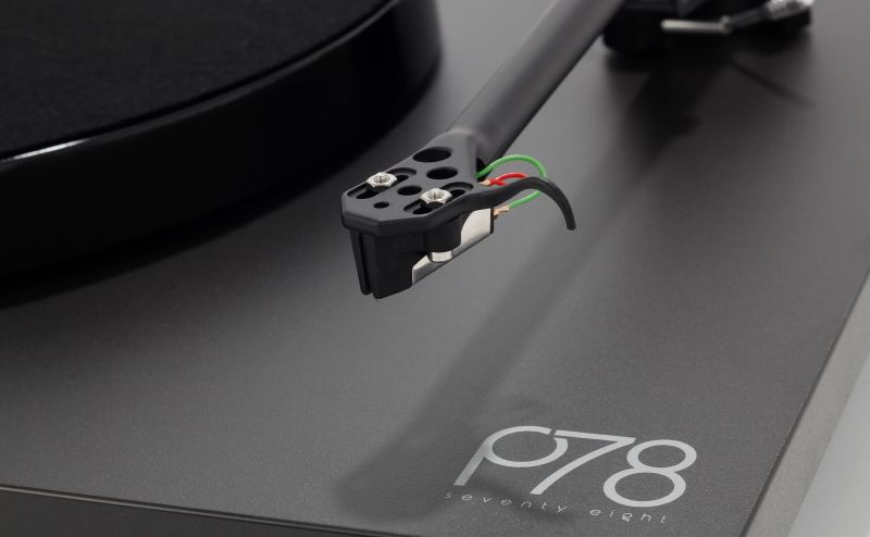 Close-up of the RB220 headshell and its cartridge tag wires above the plinth