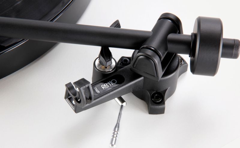 Close-up of the RB110 tonearm headshell and the factory fitted Rega Carbon cartridge