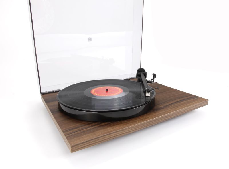 Planar 1 in the Walnut effect finish, smoked dustcover raised, record playing