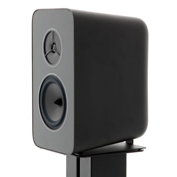 A Kyte loudspeaker seen from the front on a black stand, grey baffle and two drivers visible, sitting on the adaptor plate fitted beneath the cabinet